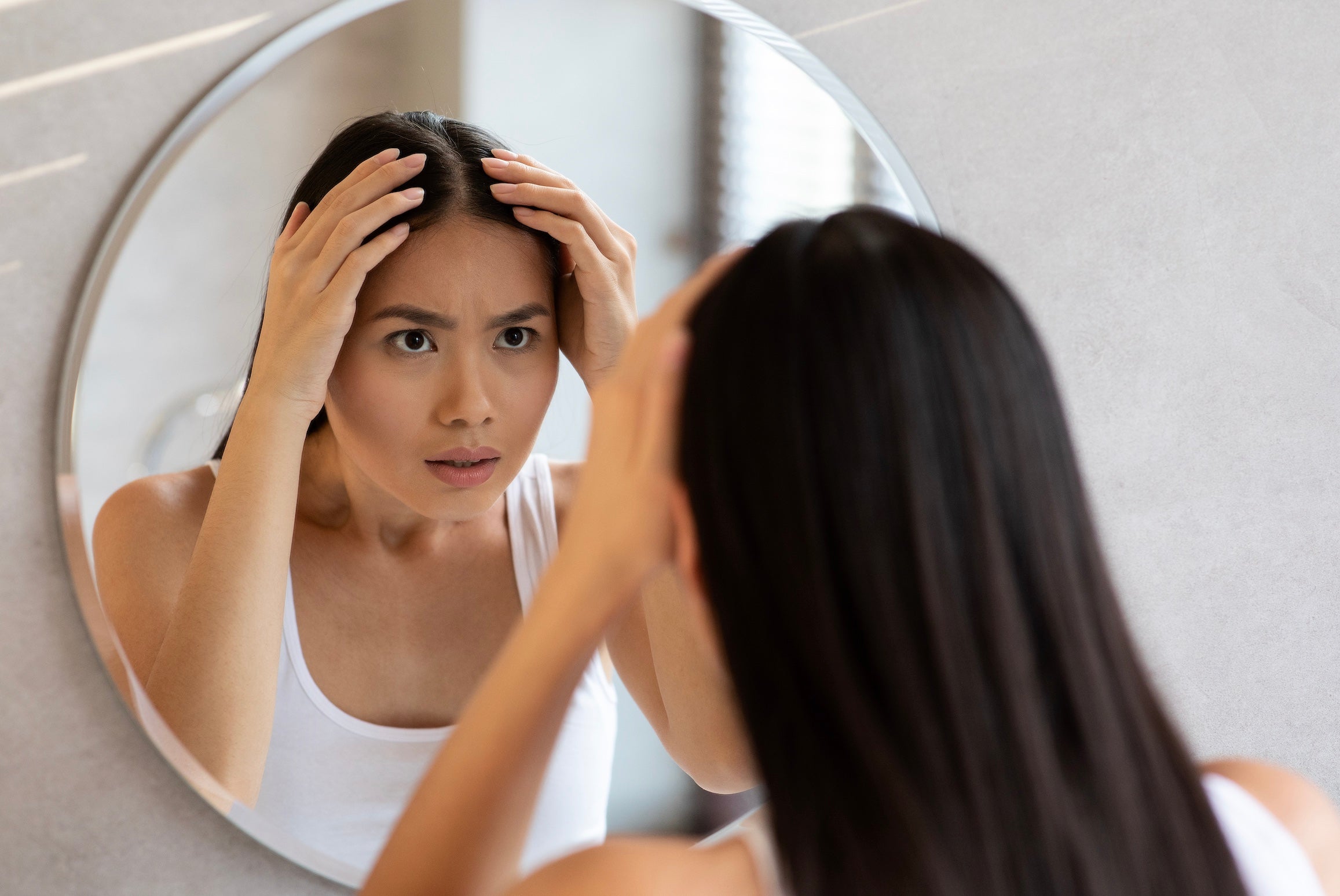 woman-looking-at-thinning-hair