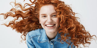 Lady smiling with glowing, healthy hair