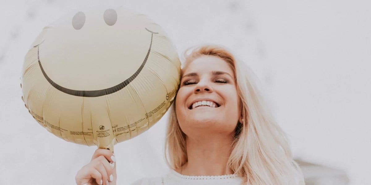 Lady smiling with a happy balloon