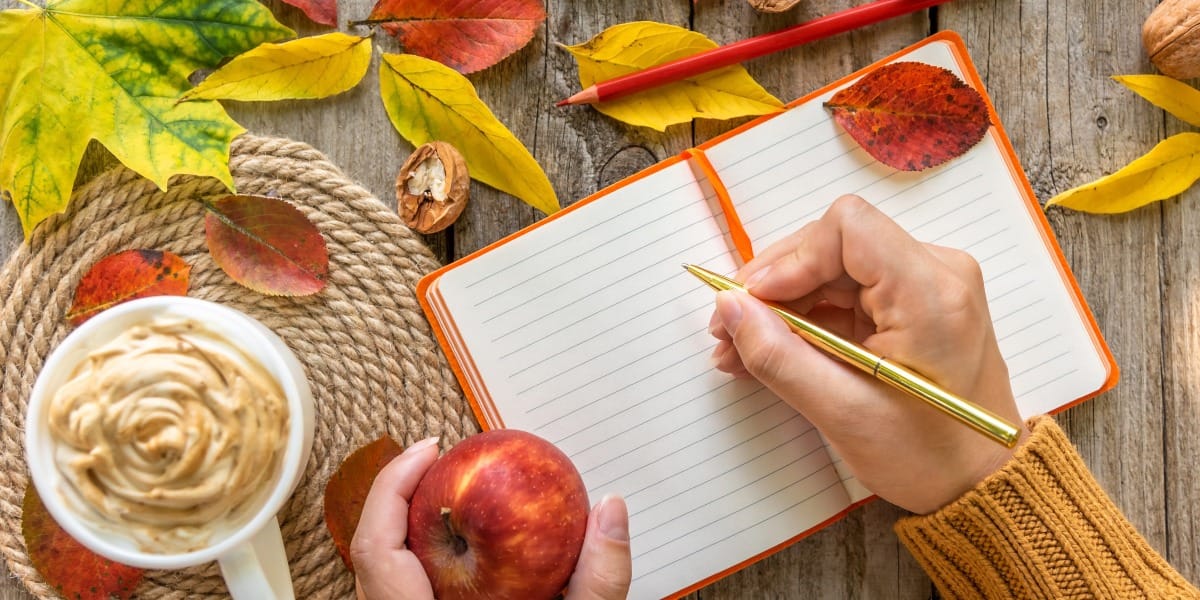 Simone Thomas writing a diary during the autumn season